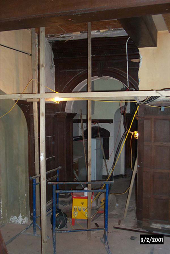 A modern façade being removed to reveal the original entrance to the Servants' Passage